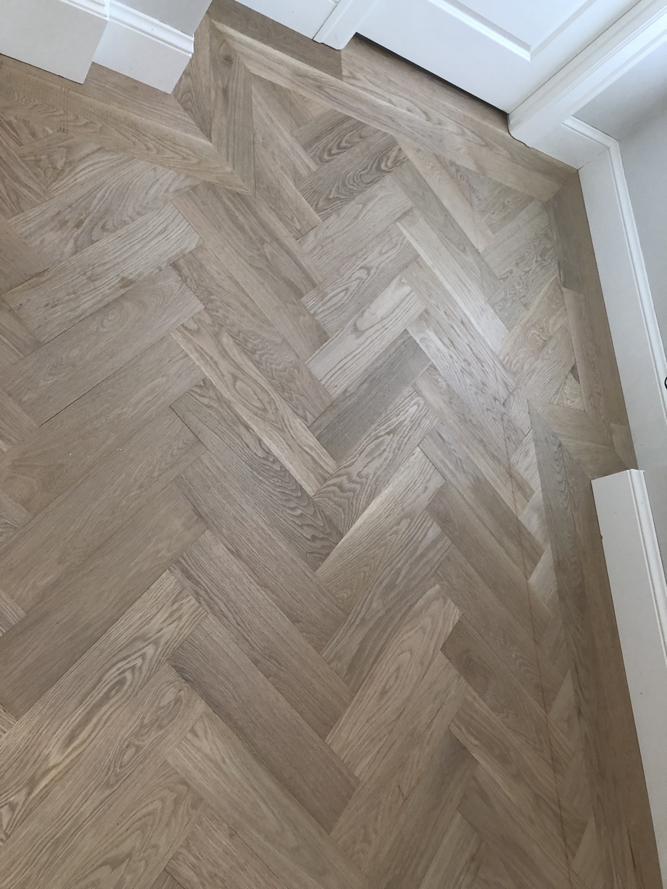 Close detail of precisely aligned herringbone wood flooring