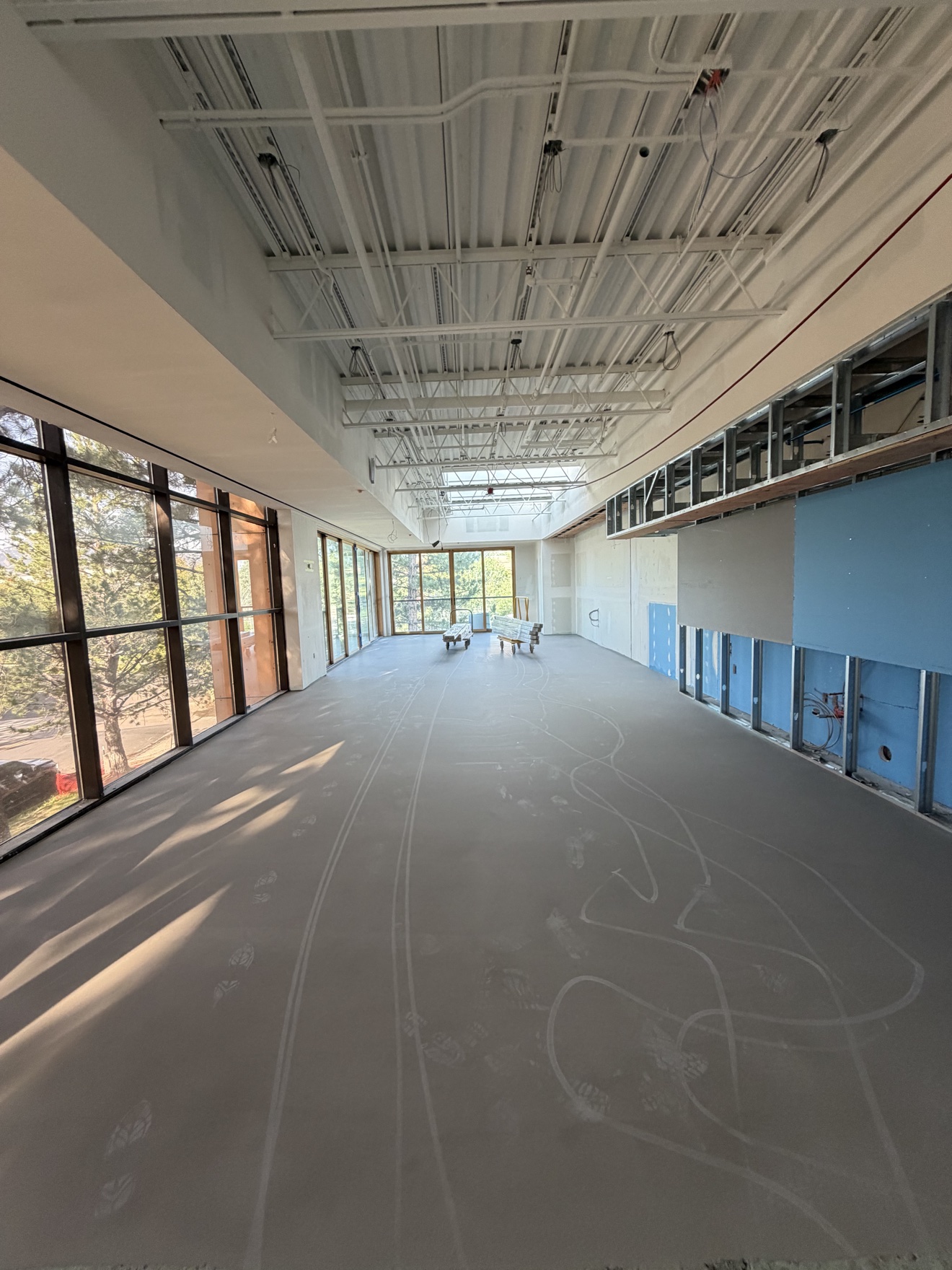 Finished self-leveling floor preparation across a large commercial interior