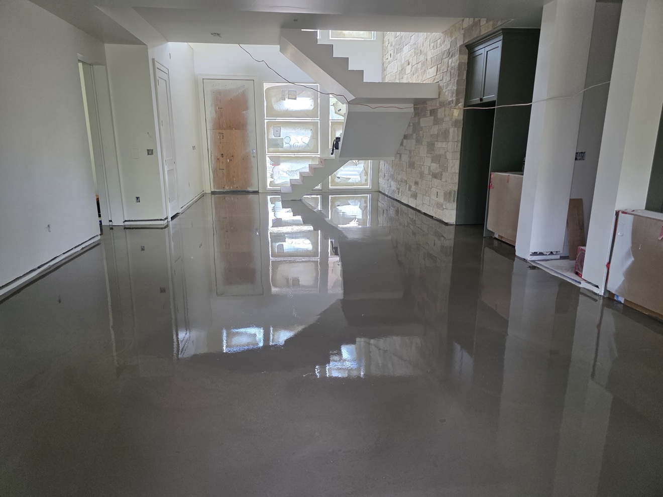 Self-leveling underlayment freshly applied across an interior floor