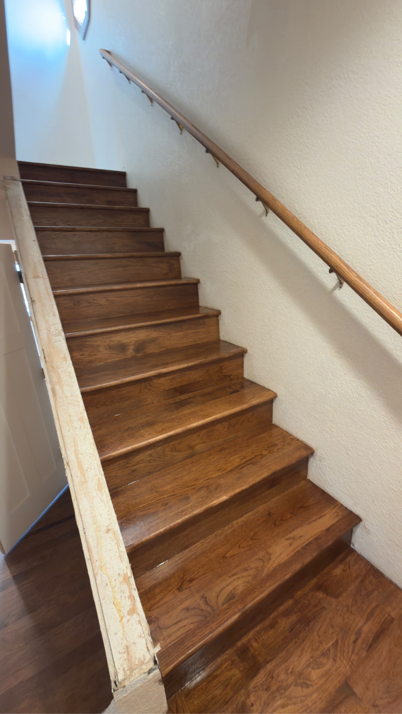 Custom staircase finished with a rich dark stain
