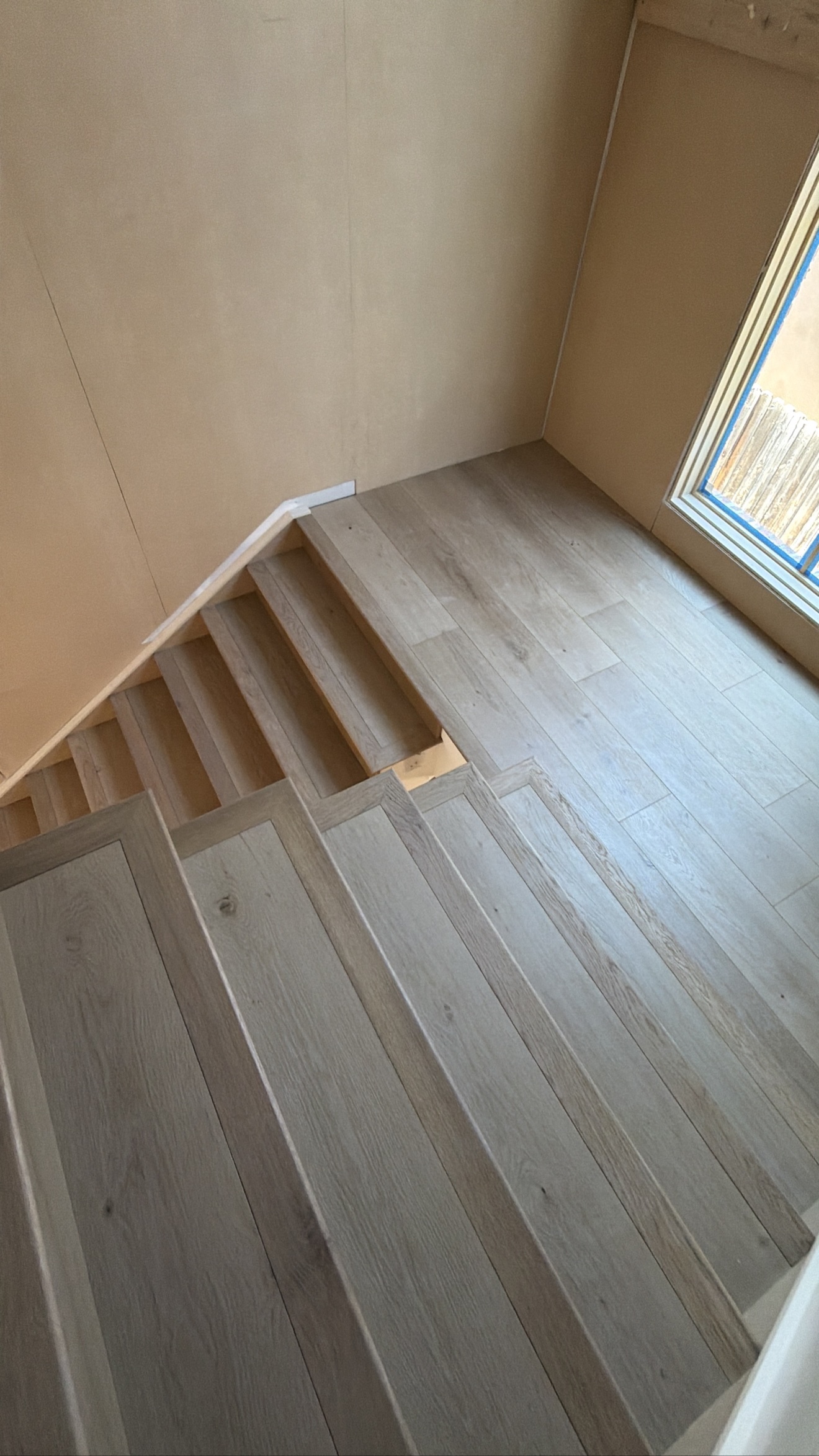 Custom staircase with a gray-wash wood finish