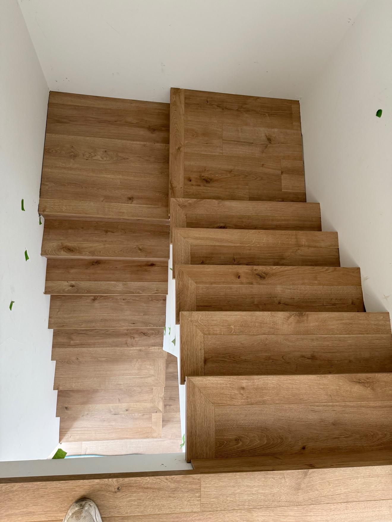 L-shaped custom white oak staircase viewed from above